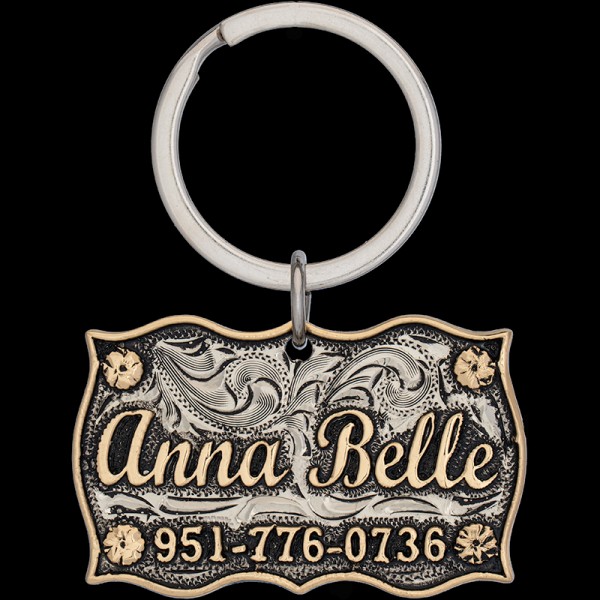 Meet the Anna Belle Custom Dog Tag! Crafted from a sturdy antiqued German silver base, adorned with jeweler's bronze letters and delicate corner flowers. Customize it now!